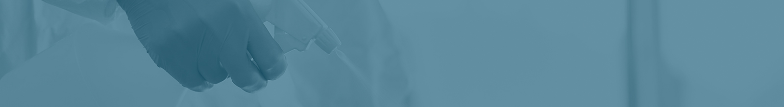 Spraying cleaning product onto surface - turquoise background